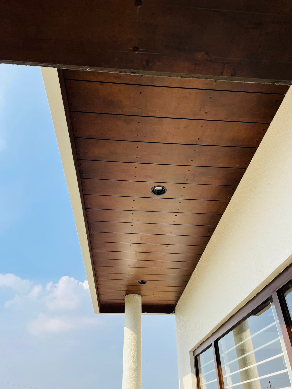 Fundermax overhead - ceiling feature cladding installation Kochi Kerala | Precise Homes